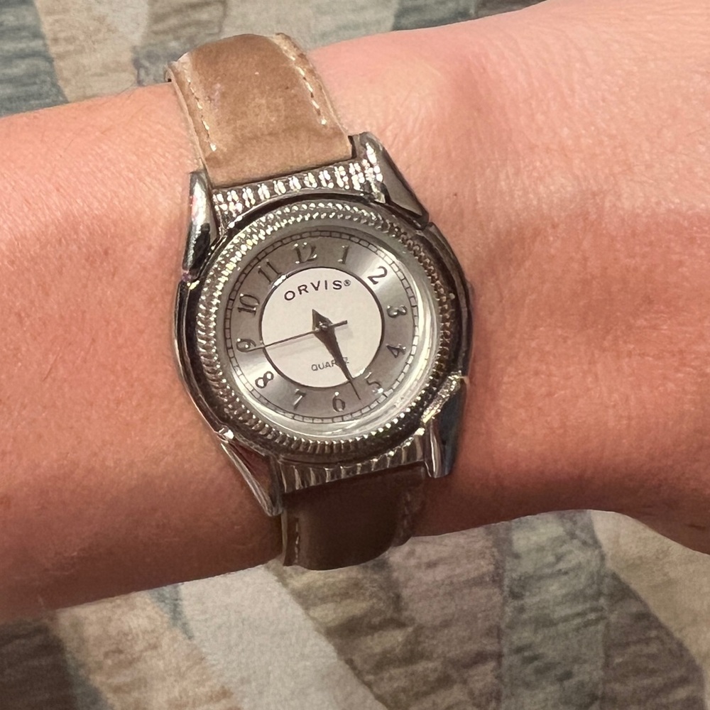 Orvis watch. Neutral color. Silver face. Still works. Good condition.